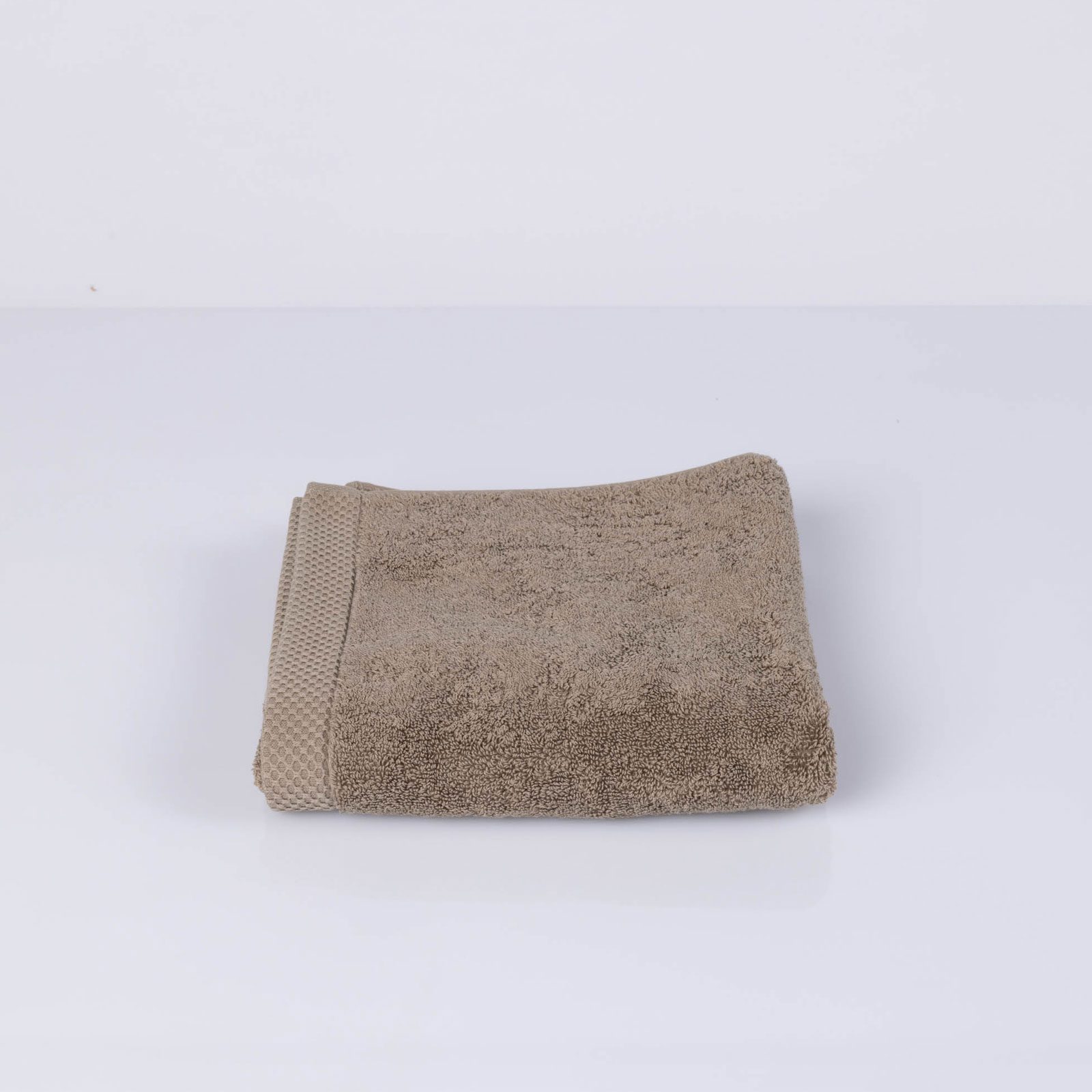 https://www.kalani-home.com/wp-content/uploads/luxury-terry-600-hand-towel-taupe-1.jpg